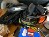 a pile of electronics on a table next to a laptop