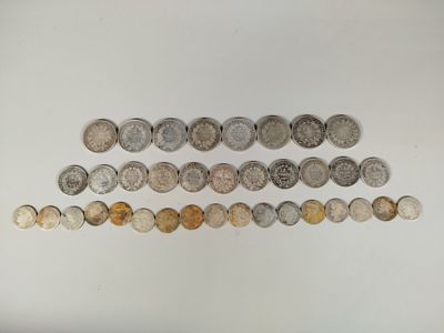 several different coins are arranged in a row on a white surface