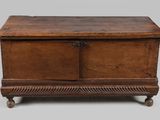 an old wooden chest sitting on top of a table