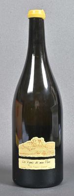 a black bottle with a yellow lid on a gray surface
