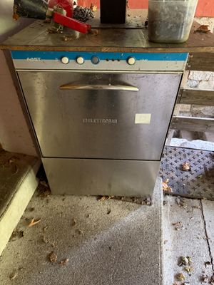 an image of a kitchen with a dishwasher and a trash can
