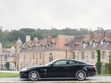 a black car parked in front of a large building