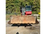 a bulldozer that is parked in the parking lot