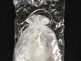 a small bag with a small white object inside of it