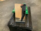 a man holding a mirror on top of a black box