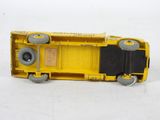 a yellow toy truck that is sitting on a white surface