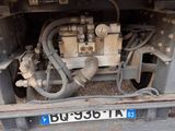 a truck that has a bunch of pipes on the back of it
