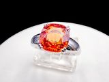 an orange ring sitting on top of a white table