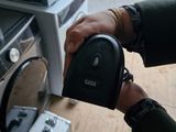 a person holding a remote control in front of a tv