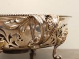 a silver bowl sitting on top of a wooden table