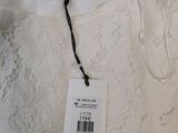 a close up of a white dress with a tag on it