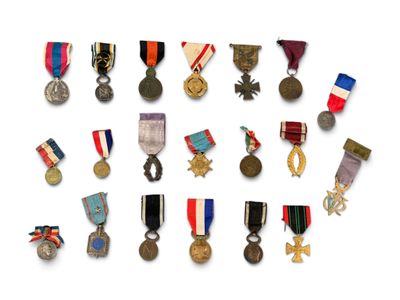 an assortment of medals and medals on a white surface
