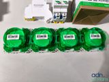 several pieces of green tape sitting on top of a table next to a box of green tape