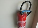 a fire extinguisor in the corner of a room