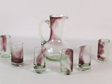 bottles and glasses are lined up on a white surface