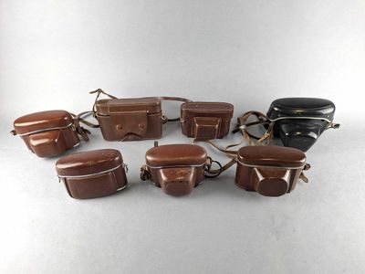 an image of a group of brown leather bags sitting on top of a table