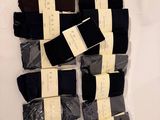 several pairs of men ' s black and brown socks on a white surface