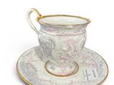 a cup and saucer sitting on a saucer
