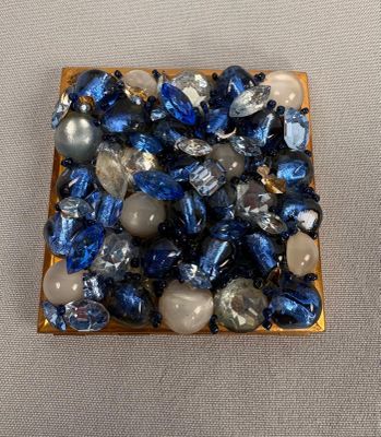 a small square of blue and white stones on a table