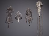 three silver brooches and a chain necklace