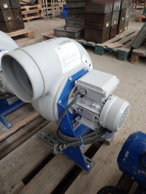 a blue and white blower sitting on a pallet in a warehouse