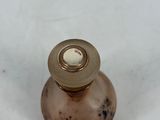 a small metal object on a white surface