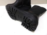 a pair of black boots that are on a table