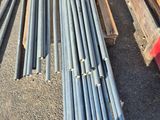 a pile of steel pipes sitting on top of a pile of wood