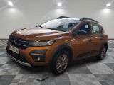la voiture orange est garée sur le sol en damier d'un garage