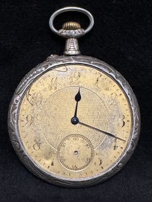 a silver pocket watch on a black background