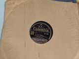 an old record is sitting on a table next to a bag