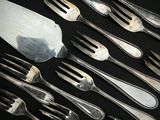 beaucoup de fourchettes et de cuillères sur une table noire