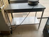 a table with a bowl on top of it on the floor