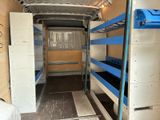 a picture of the inside of a van with bunk beds