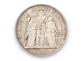 an old silver coin with the image of a man and a woman on it