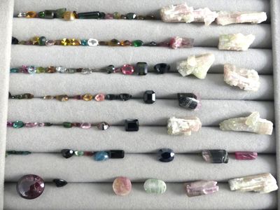 many different colored stones and beads in a display case