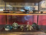 a display case with a variety of antique items in it