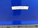 a close up of a blue car with a sticker on it