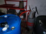a blue barrel sitting next to a red shelf and a blue barrel