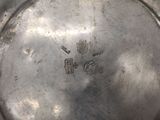 a close up of a silver plate with a chinese writing on it