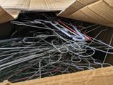 a cardboard box filled with lots of scissors and wire