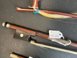 several different types of bows and arrows are displayed on a table