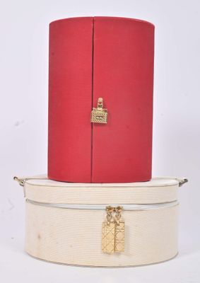 two suitcases stacked on top of each other on a white surface