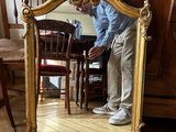 a man that is standing in front of a mirror
