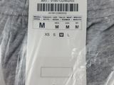 the back of a pair of men ' s gray sweatpants with a tag on it