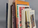 several books are stacked on top of each other on a table