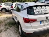 a white car parked in a lot with other cars in the background