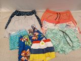 several pairs of shorts are laid out on the floor