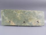 an image of a piece of green marble with holes in it