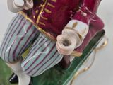 a figurine of a man sitting on a sled